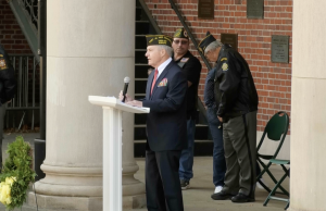 Retired Major Roger Johnson stands on College Green to deliver his Veterans Day address.